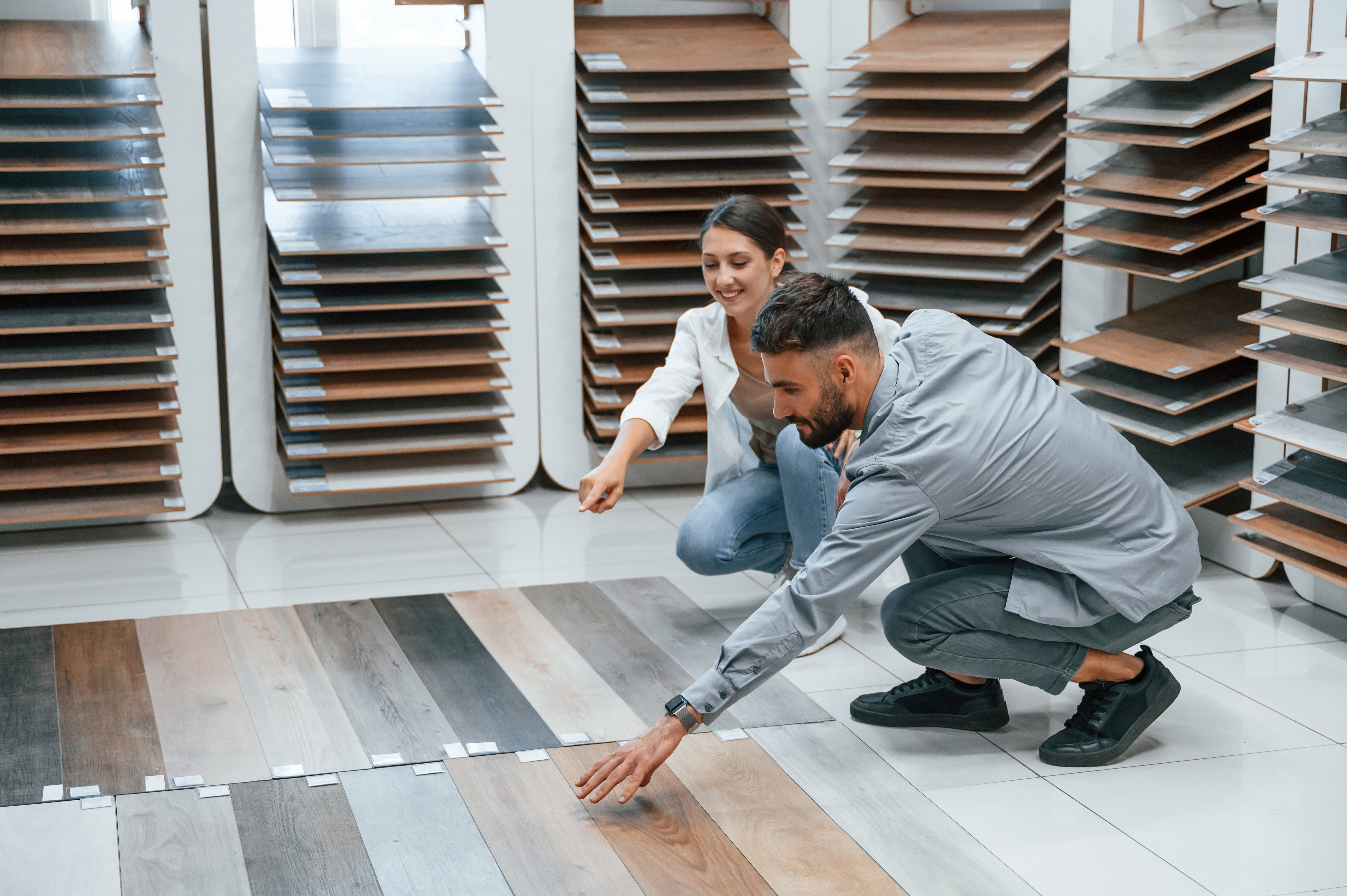 Choosing parquet. Woman and man is in the store of goods for the home.