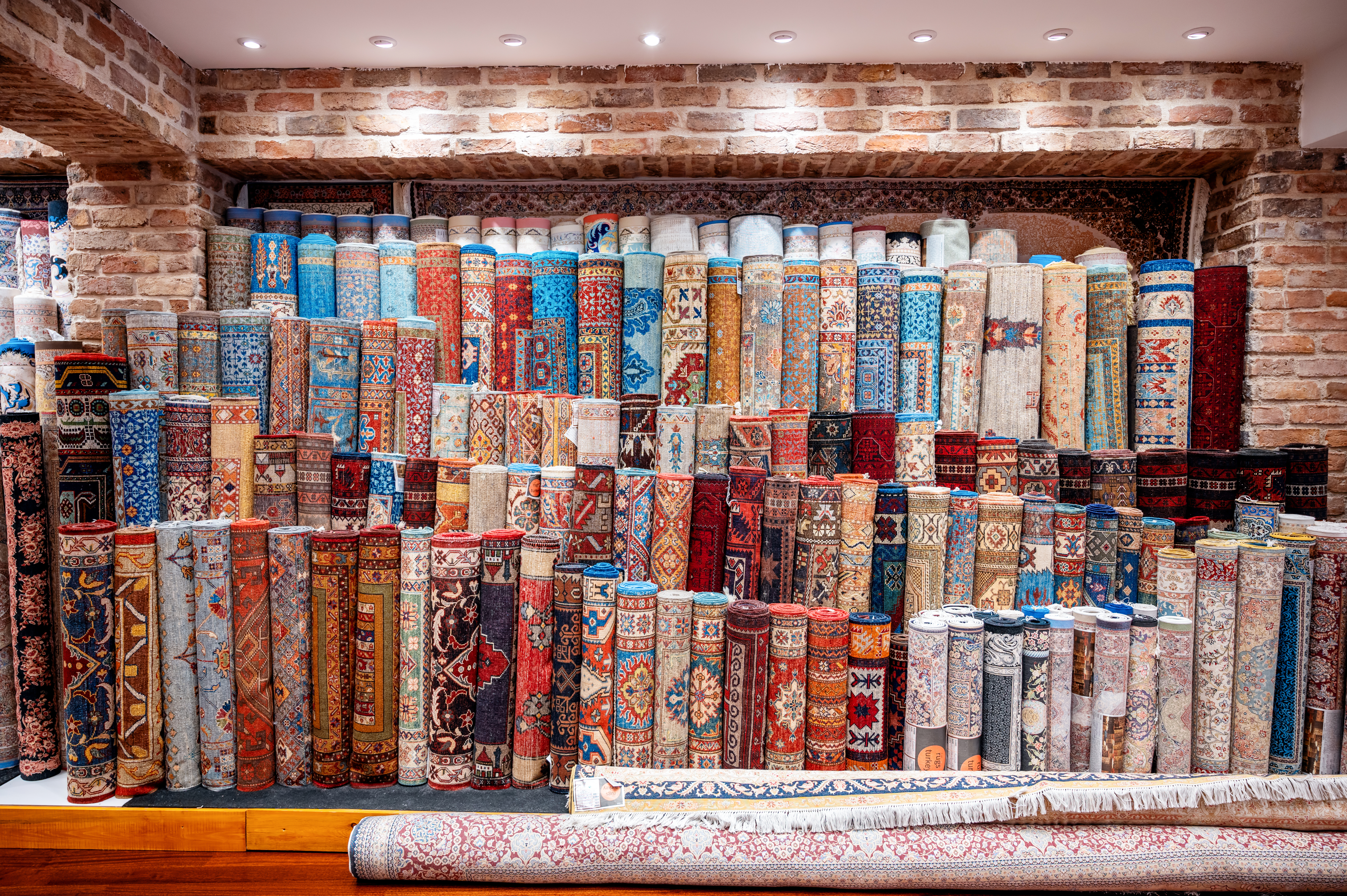 View of multiple carpets for sale at the Grand Bazaar in Istanbul, Turkey